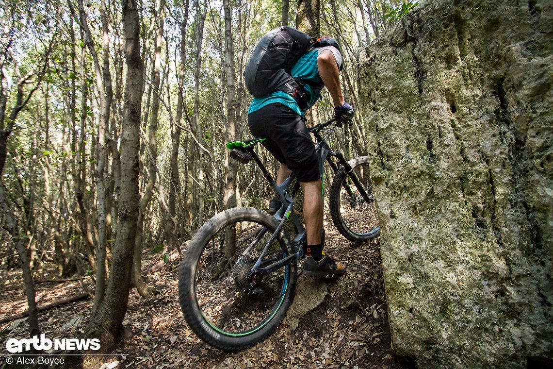 Maintain your weight forward which will bring the rear of the bike along, keep pedalling to maintain momentum